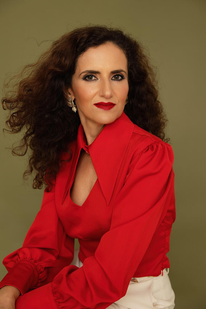 Photo of curly woman in red, Berlin studio photoshoot